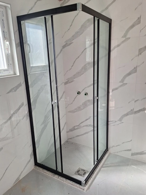 tuš kabina sa crnim aluminijumskim okvirom i transparentnom bojom stakla